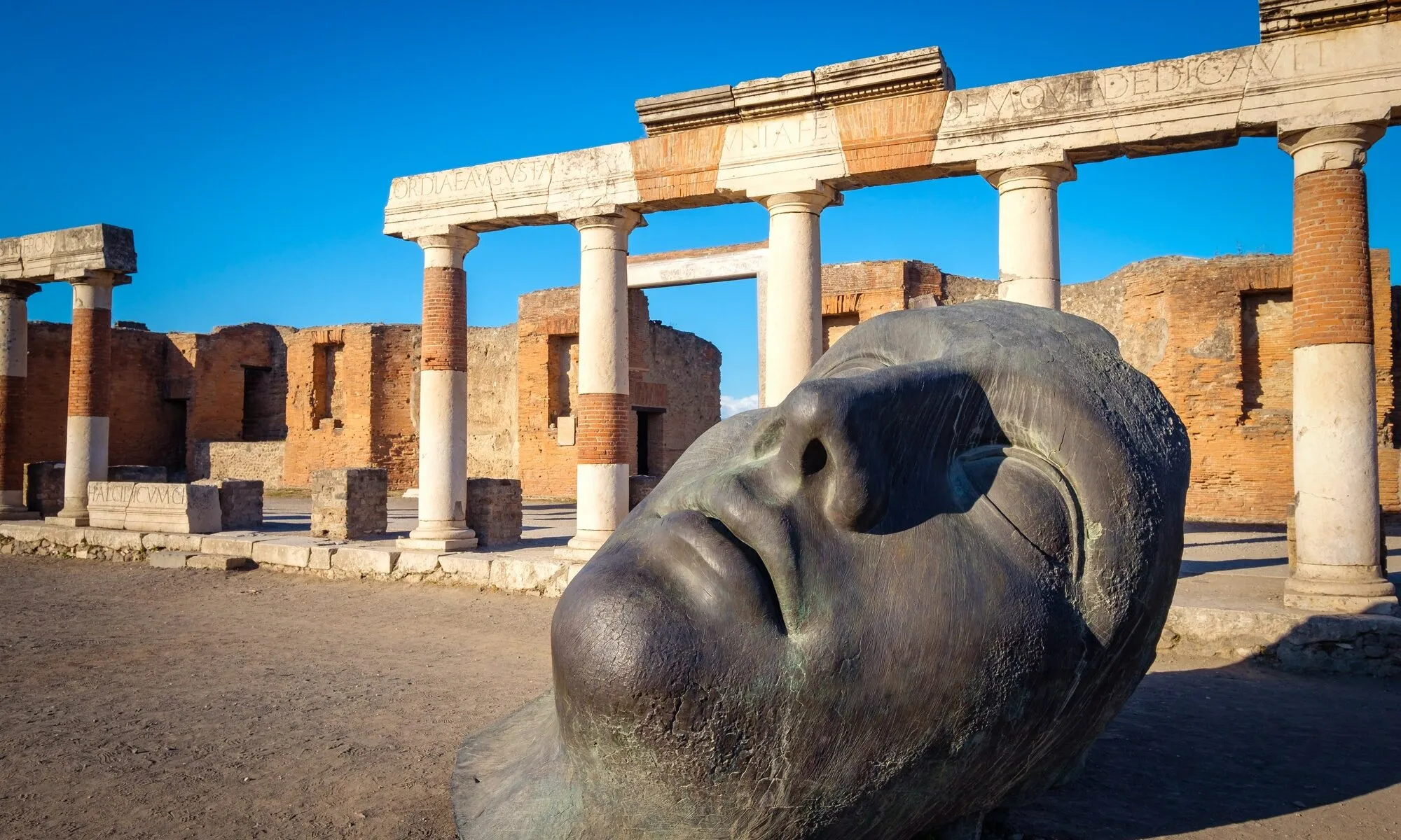Brick and stone facades along an excavated Pompeii street
