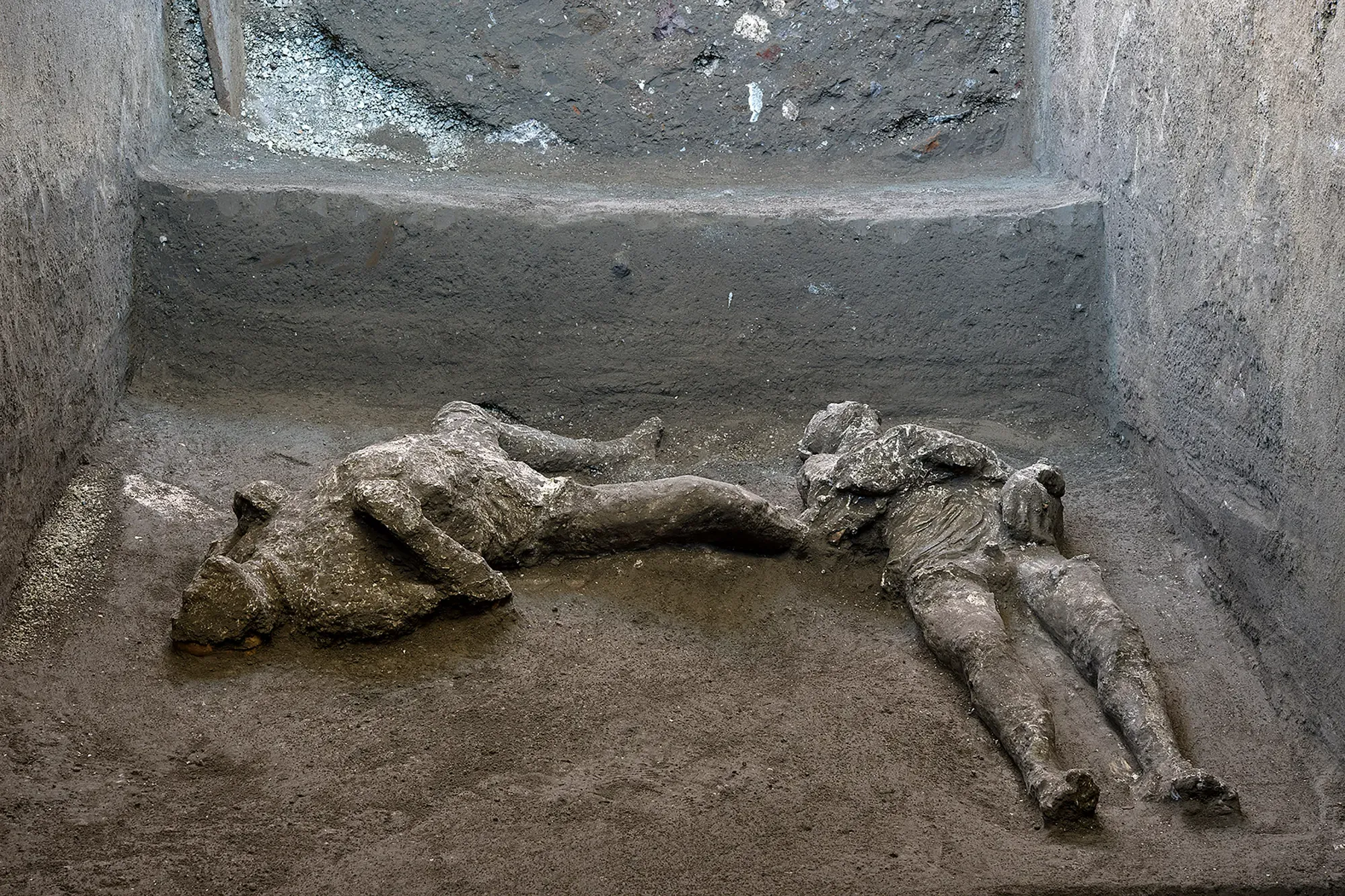 Close-up of plaster casts showing preserved body details from Pompeii